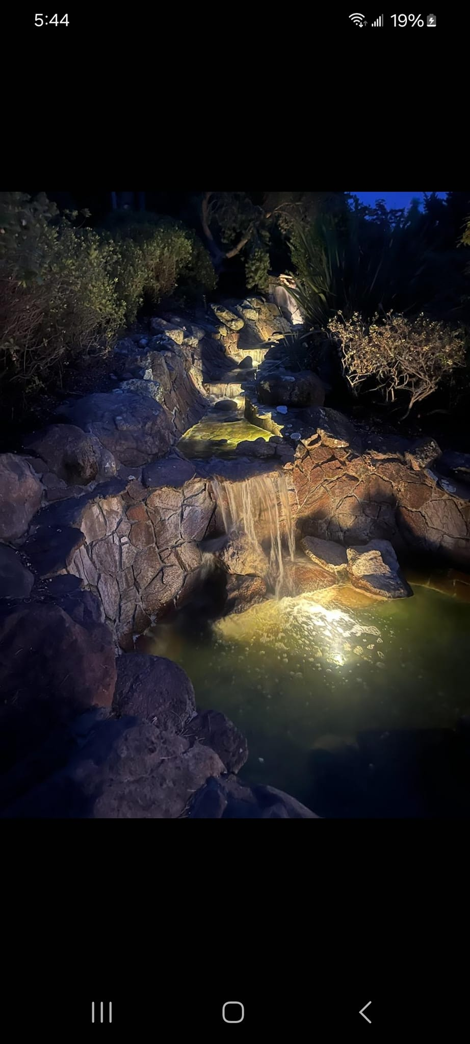 Man-made waterfall and pool in a garden setting